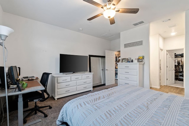 carpeted bedroom with ceiling fan and a closet