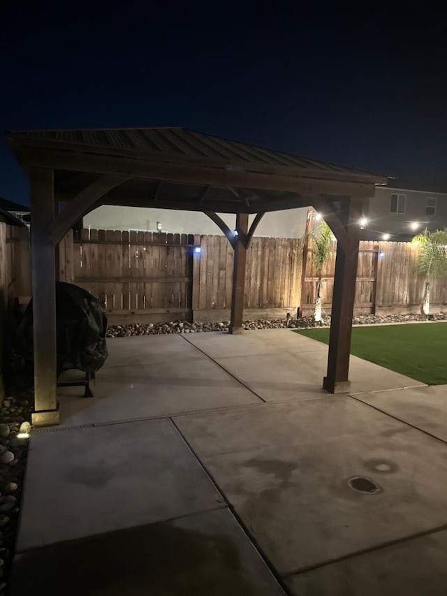 patio at night featuring a gazebo