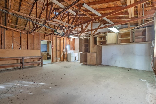 misc room featuring lofted ceiling and concrete flooring