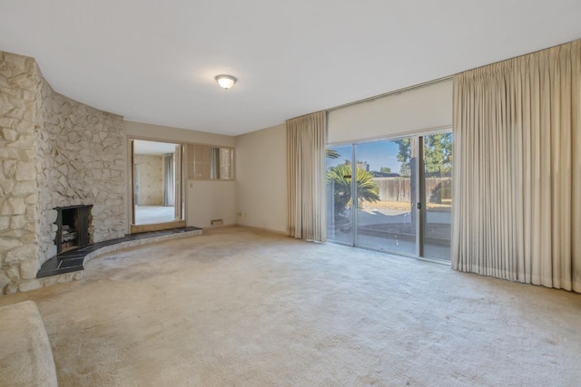 unfurnished living room featuring carpet and a fireplace