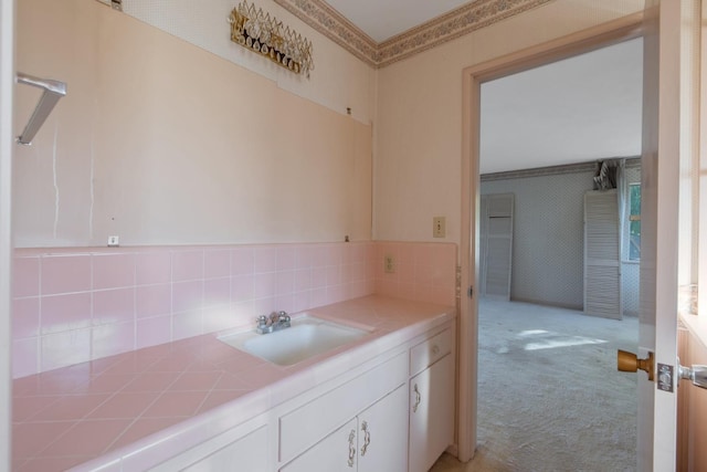 bathroom featuring vanity and decorative backsplash