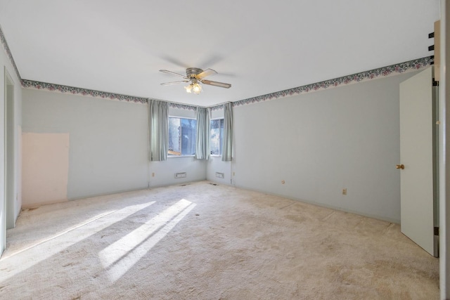 carpeted empty room featuring ceiling fan