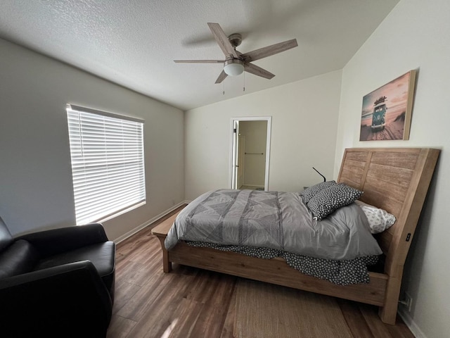 bedroom with hardwood / wood-style floors, a textured ceiling, vaulted ceiling, and ceiling fan