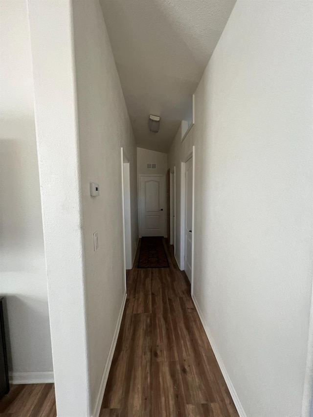 corridor with dark hardwood / wood-style floors