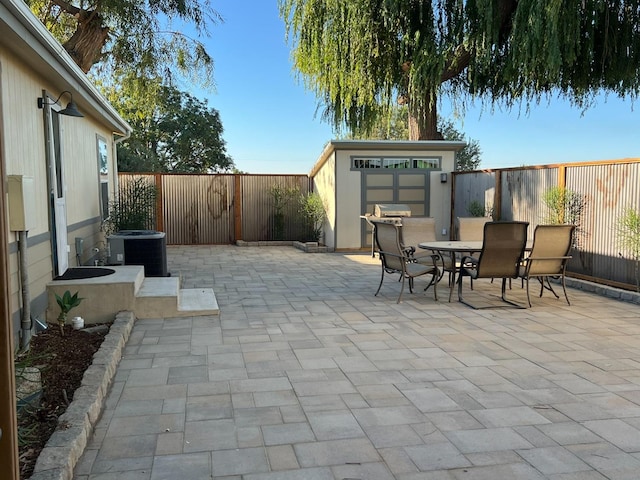 view of patio / terrace with a storage shed and central AC