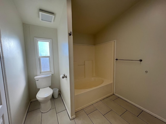 bathroom featuring toilet, tile patterned floors, and lofted ceiling