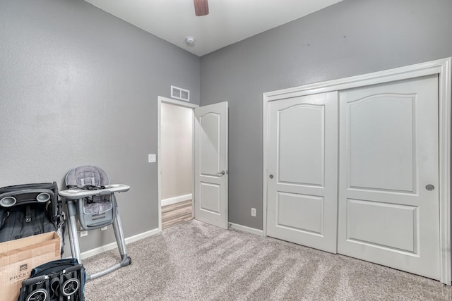 interior space with light carpet and ceiling fan