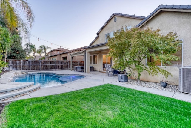 view of pool with central air condition unit, a patio, and a lawn