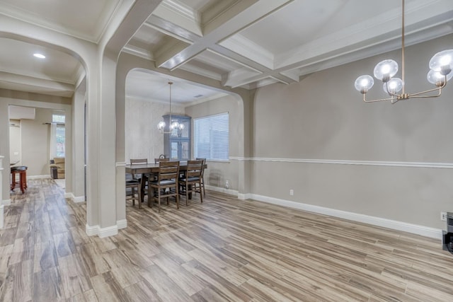 dining space with ornamental molding, beamed ceiling, light hardwood / wood-style floors, a notable chandelier, and coffered ceiling