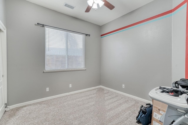 unfurnished office with ceiling fan, a healthy amount of sunlight, and carpet flooring