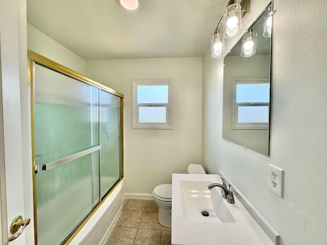 full bathroom featuring vanity, toilet, tile patterned floors, and enclosed tub / shower combo