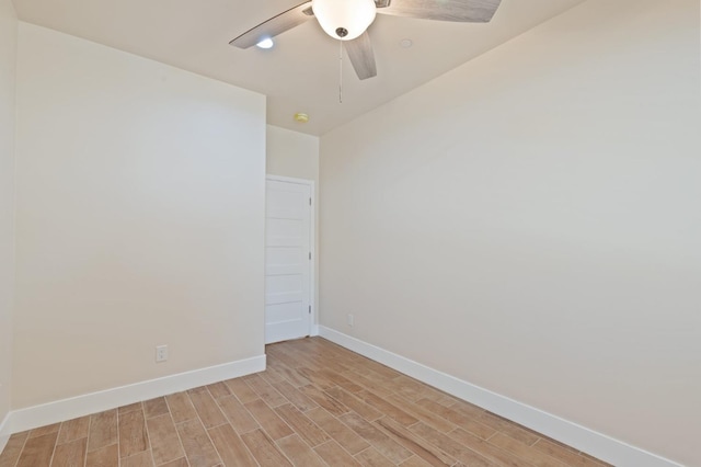 empty room with light wood finished floors, ceiling fan, and baseboards