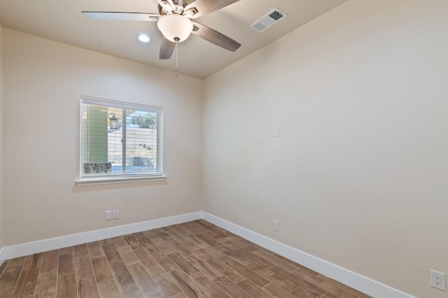 unfurnished room with a ceiling fan, light wood-style flooring, visible vents, and baseboards