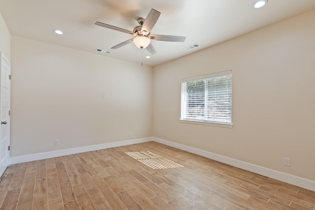 unfurnished room with baseboards, visible vents, and light wood finished floors