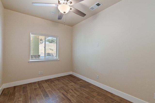 empty room with baseboards, visible vents, ceiling fan, and wood finished floors