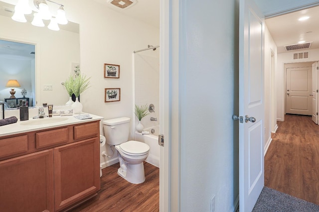 full bathroom with a notable chandelier, toilet, vanity, shower / bathtub combination, and hardwood / wood-style flooring