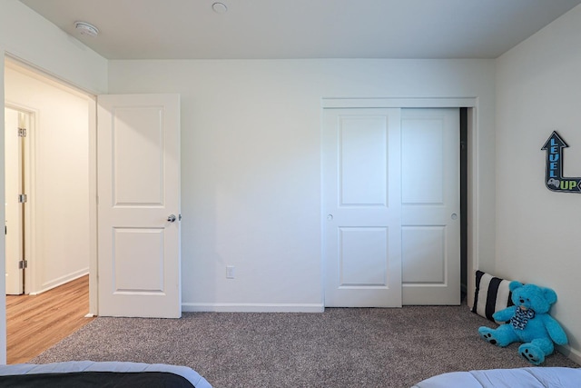 unfurnished bedroom featuring carpet flooring and a closet