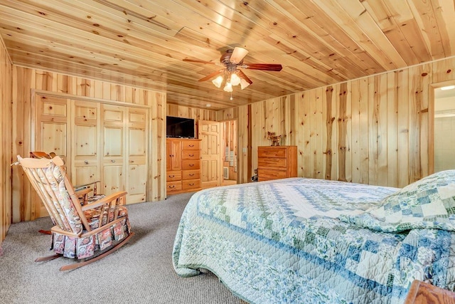 carpeted bedroom featuring ceiling fan, wooden ceiling, and wooden walls