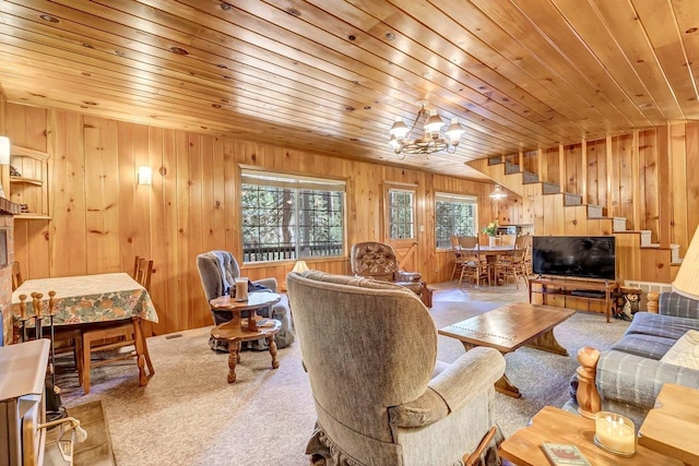 living room with wood walls, carpet flooring, an inviting chandelier, and wooden ceiling