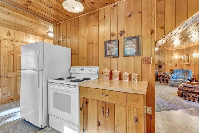 kitchen with wooden walls, light carpet, wood ceiling, and white appliances