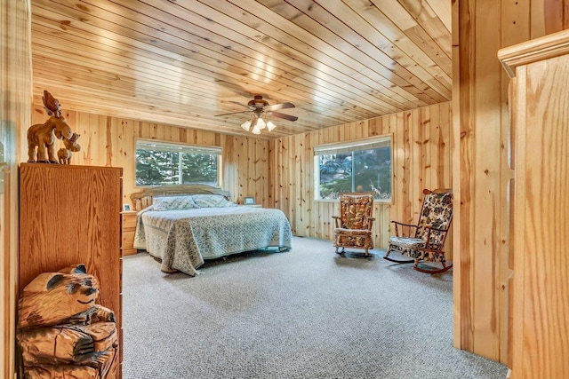 bedroom featuring ceiling fan, carpet flooring, multiple windows, and wood ceiling