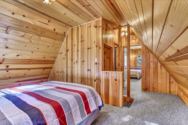 unfurnished bedroom with wooden walls, vaulted ceiling, carpet flooring, and wooden ceiling