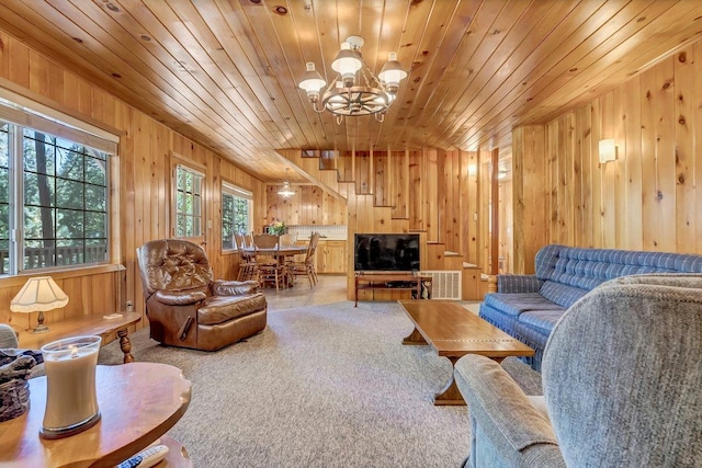 living room with carpet, wood ceiling, an inviting chandelier, and wood walls