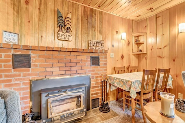 interior space with carpet floors, wooden walls, and wooden ceiling