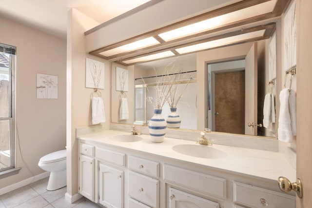 bathroom featuring tile patterned floors, vanity, and toilet