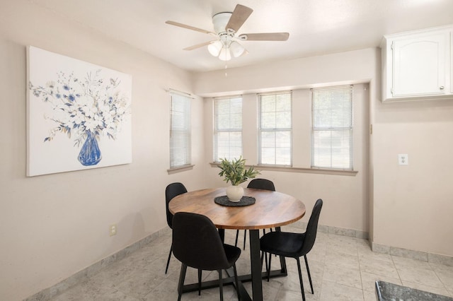 tiled dining room featuring ceiling fan