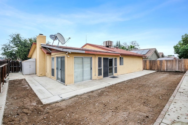 back of property featuring central AC unit and a patio area