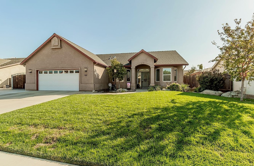 view of front of home featuring a garage and a front lawn