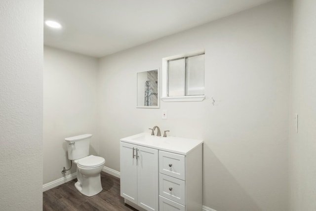 bathroom with vanity, hardwood / wood-style flooring, and toilet