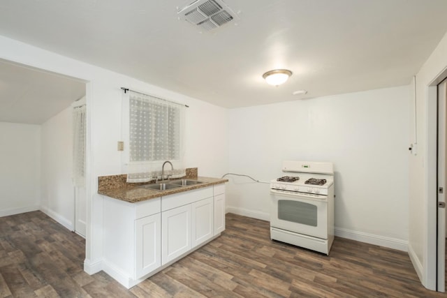 kitchen featuring white gas range, white cabinetry, sink, and dark hardwood / wood-style flooring