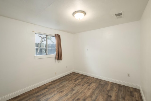 unfurnished room featuring dark hardwood / wood-style flooring