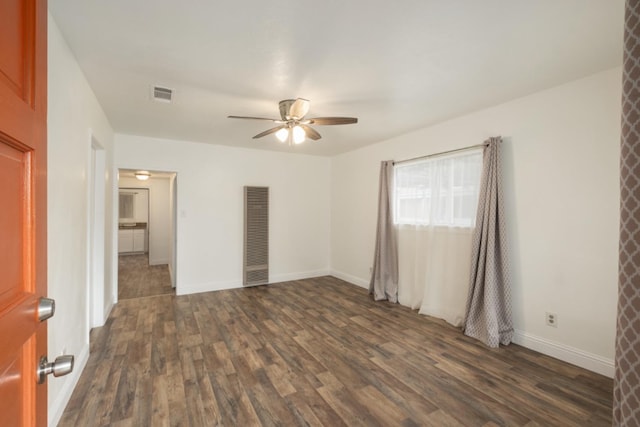 interior space featuring dark wood-type flooring and ceiling fan