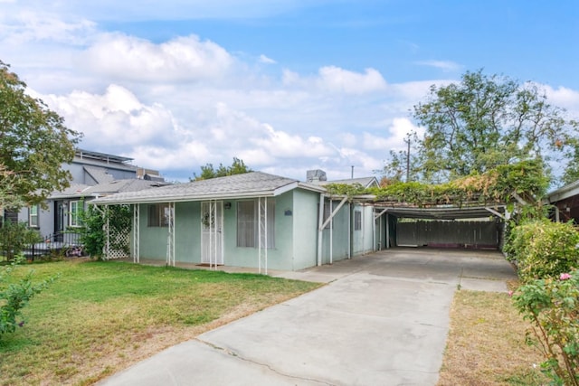 ranch-style house with a carport and a front yard