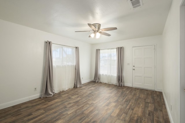 empty room featuring ceiling fan and dark hardwood / wood-style flooring