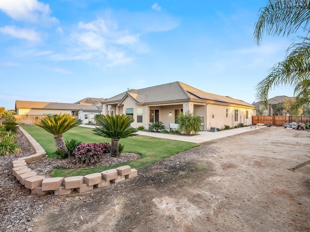 ranch-style home featuring a front yard