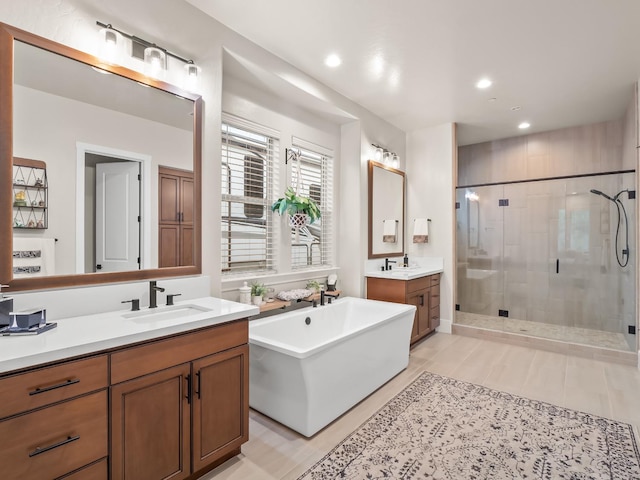 bathroom featuring tile patterned floors, vanity, and separate shower and tub