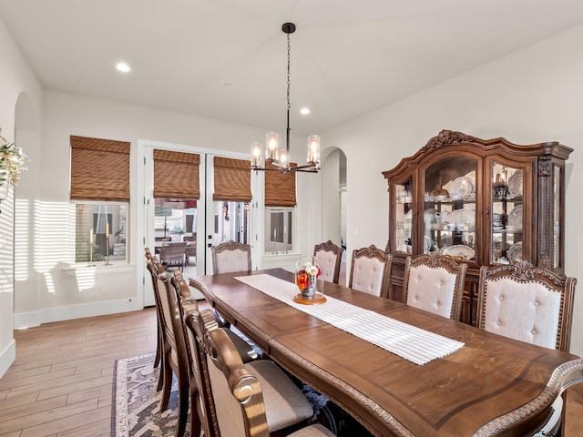 dining area with an inviting chandelier and light wood-type flooring