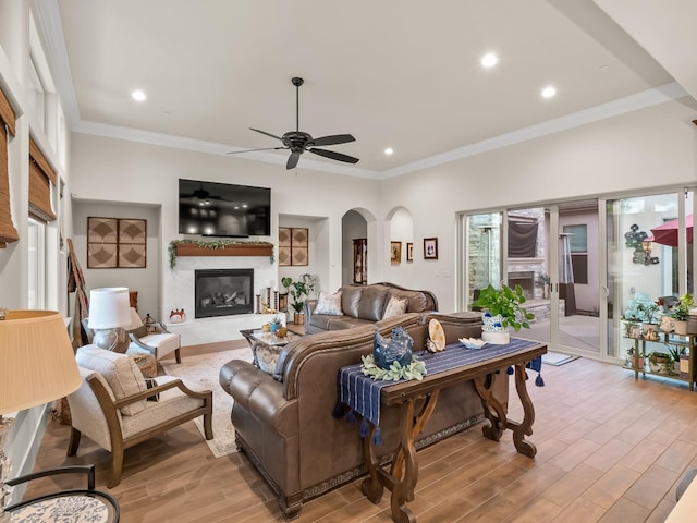 living room with ceiling fan and ornamental molding