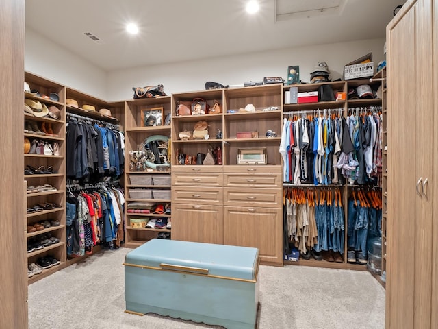 walk in closet featuring light colored carpet