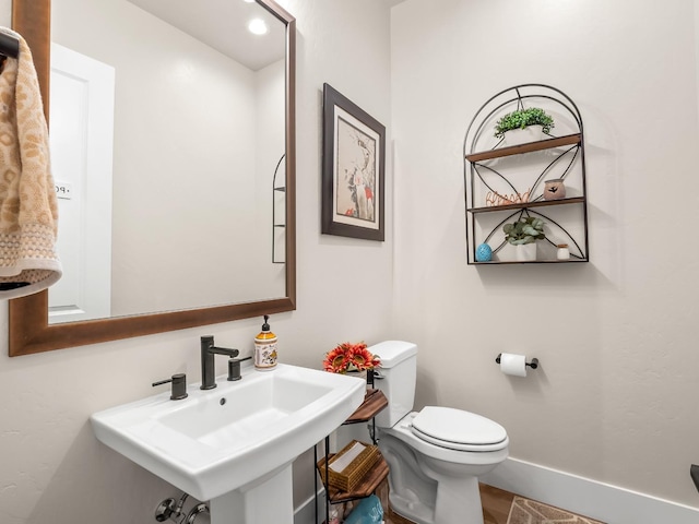 bathroom featuring toilet and sink