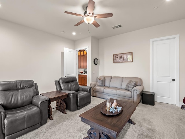 living room with ceiling fan and light colored carpet