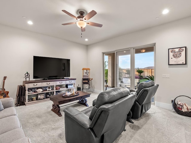 carpeted living room with ceiling fan