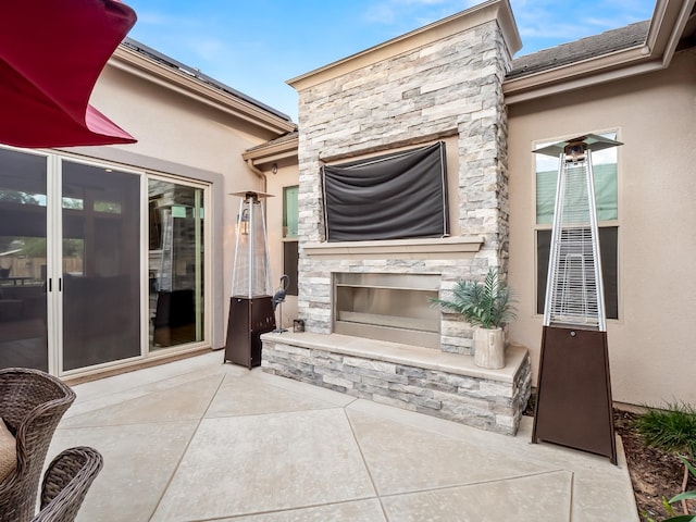 view of patio / terrace with a stone fireplace