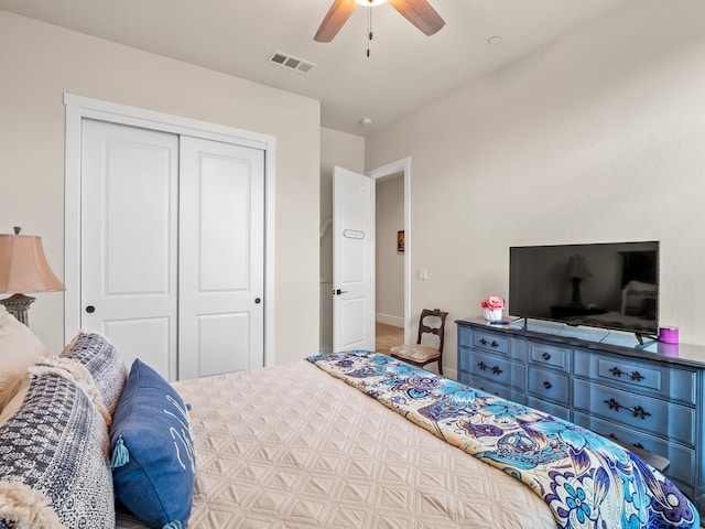 bedroom with ceiling fan and a closet