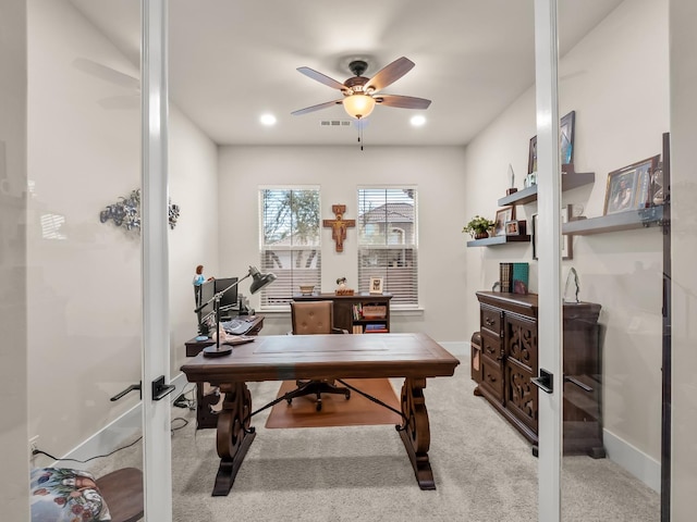 office space featuring light carpet and ceiling fan