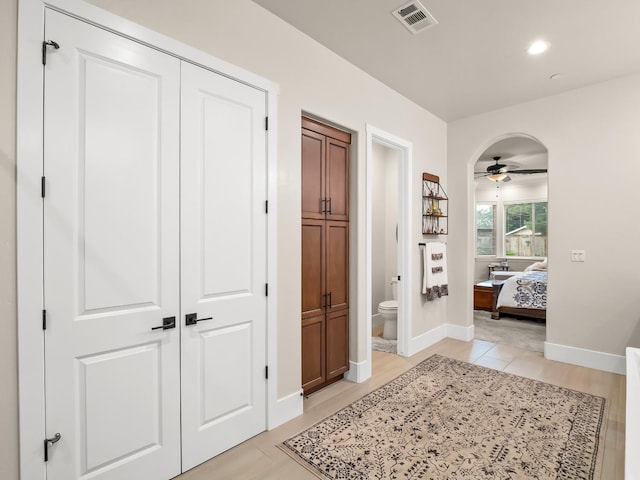 corridor featuring light tile patterned floors